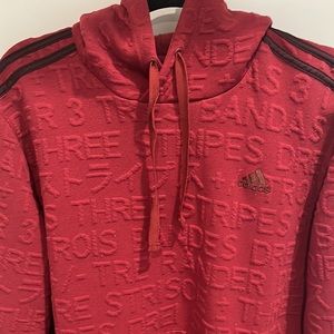 Adidas hoodie with 3 stripes written in all languages.